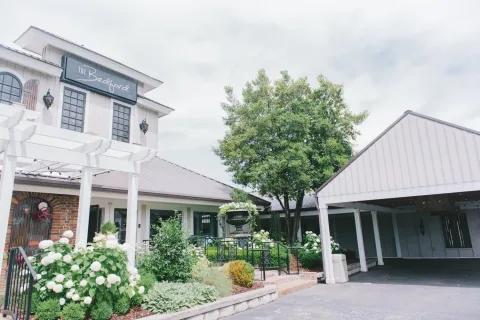 exterior of a commercial building with flowers in front