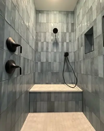Dark blue and gray tiled master walk-in shower