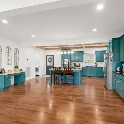 large open kitchen with turquoise cabinets 