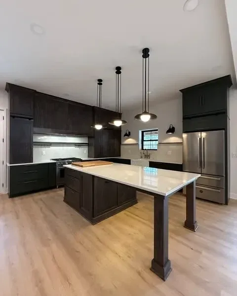 Custom kitchen with waterfall-edge quartz island and pendant lighting
