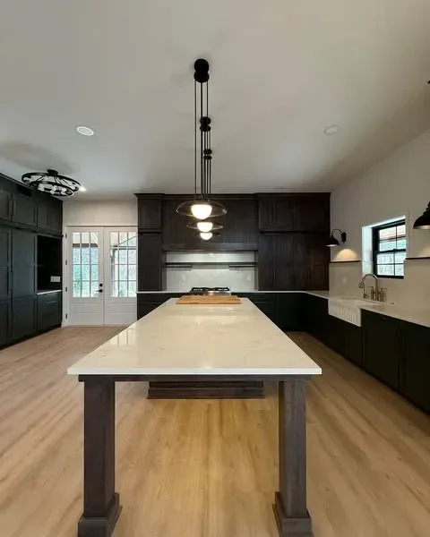 Kitchen with tiered pendant chandelier and French doors to the outdoors