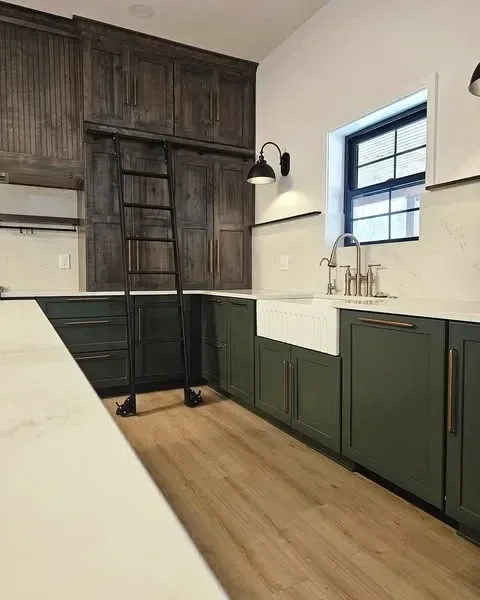 Kitchen pantry wall with built-in library ladder and farmhouse sink